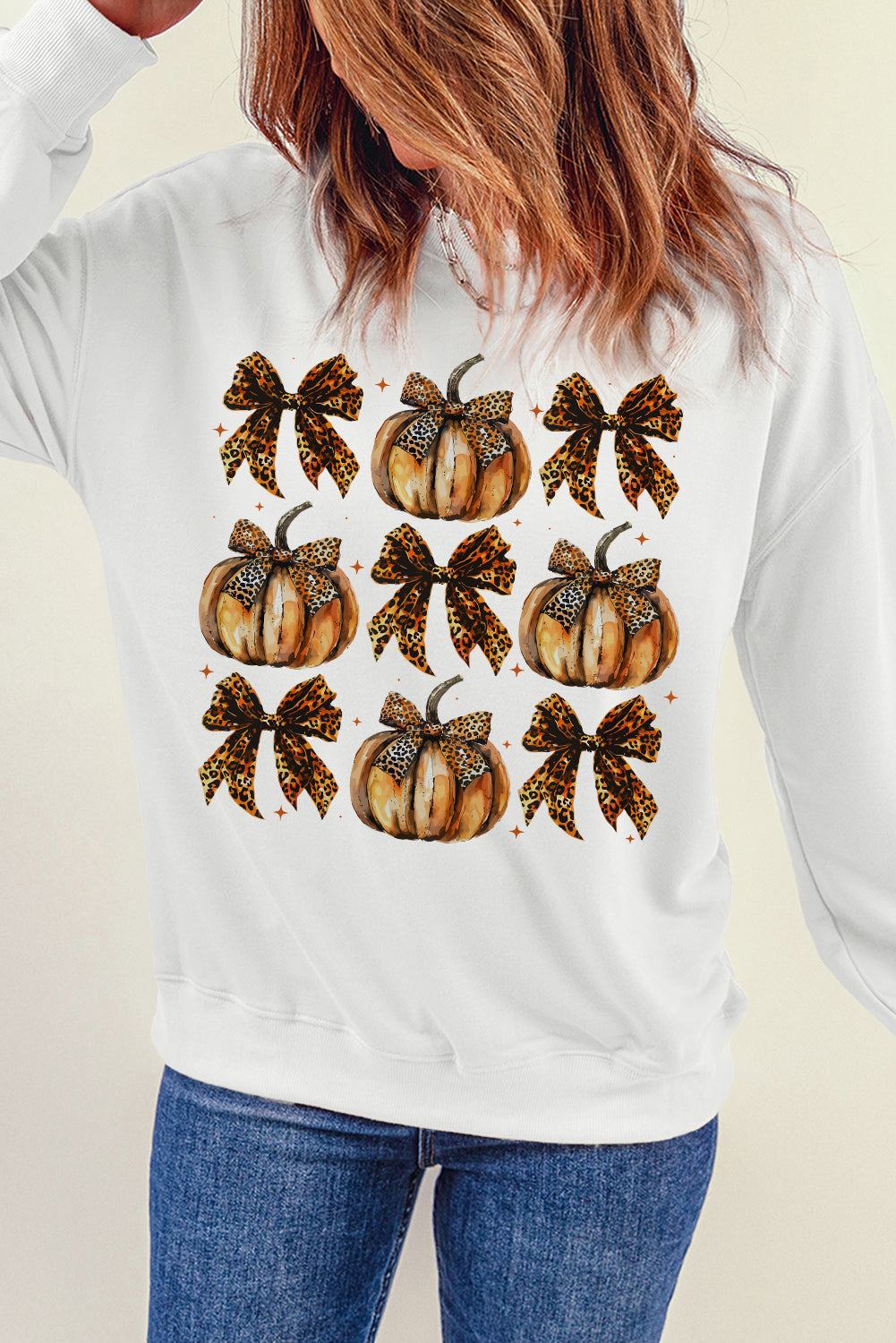 Pumpkin and bow graphic long sleeve sweatshirt with opaque fabric.