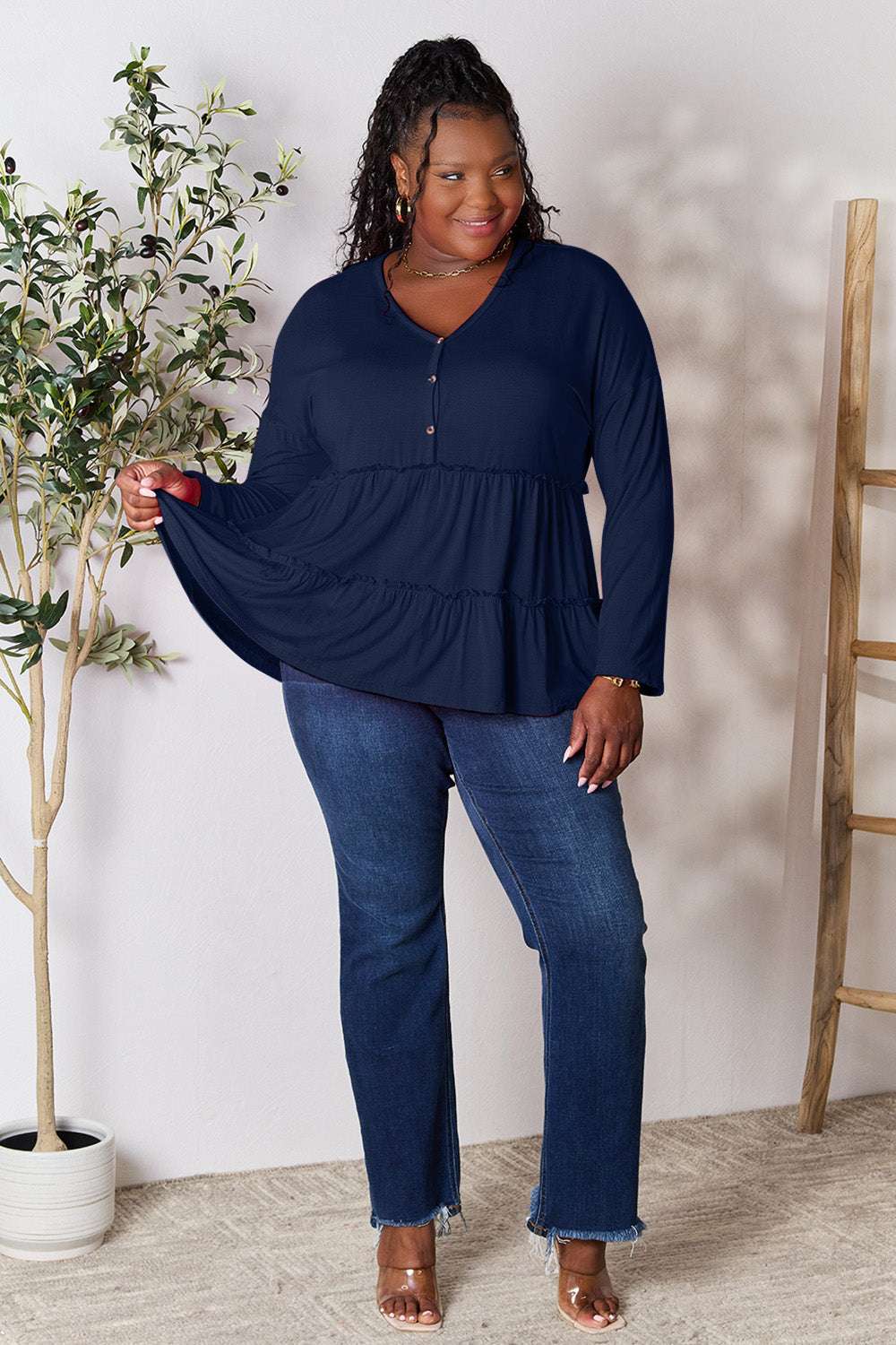 Half button long sleeve ruffle hem blouse in navy blue.