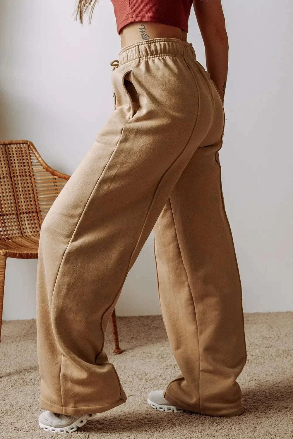 Drawstring wide leg pants with pockets, featuring a relaxed fit and comfortable fabric blend of polyester and cotton.