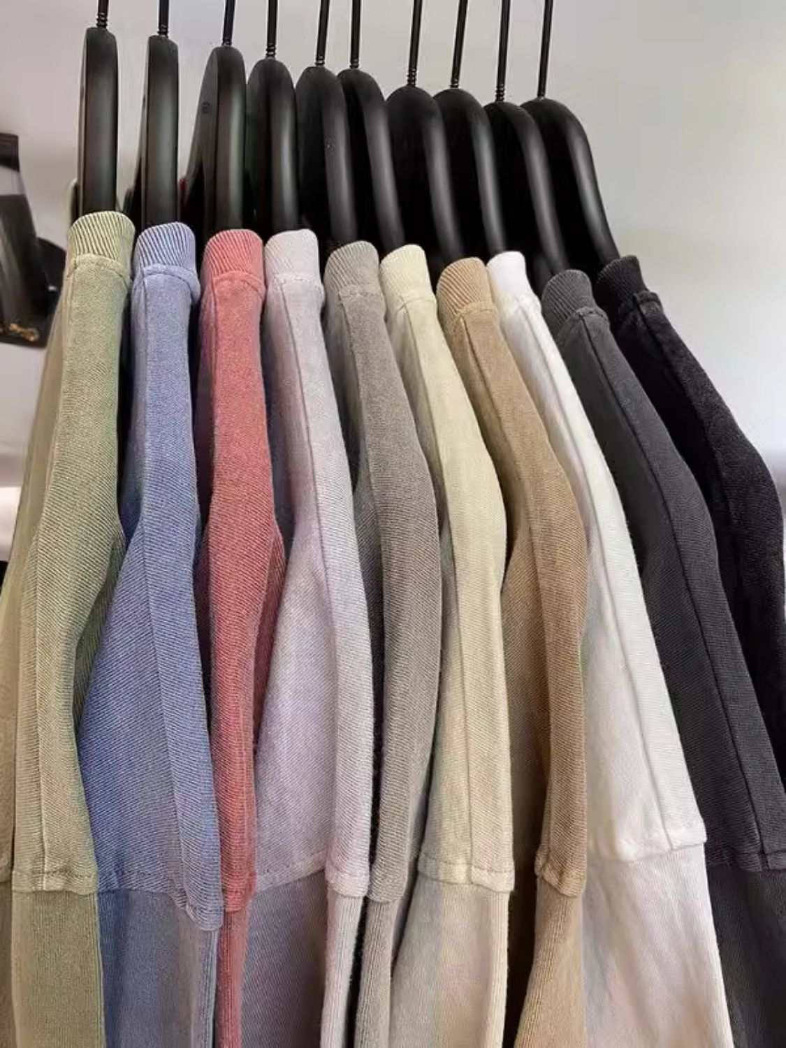 Men's round neck short sleeve t-shirts in various colors on hangers.