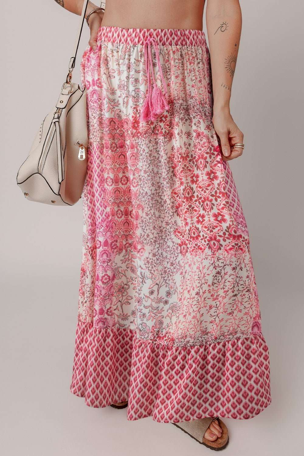 Printed tassel drawstring high waist maxi skirt in pink and white pattern.