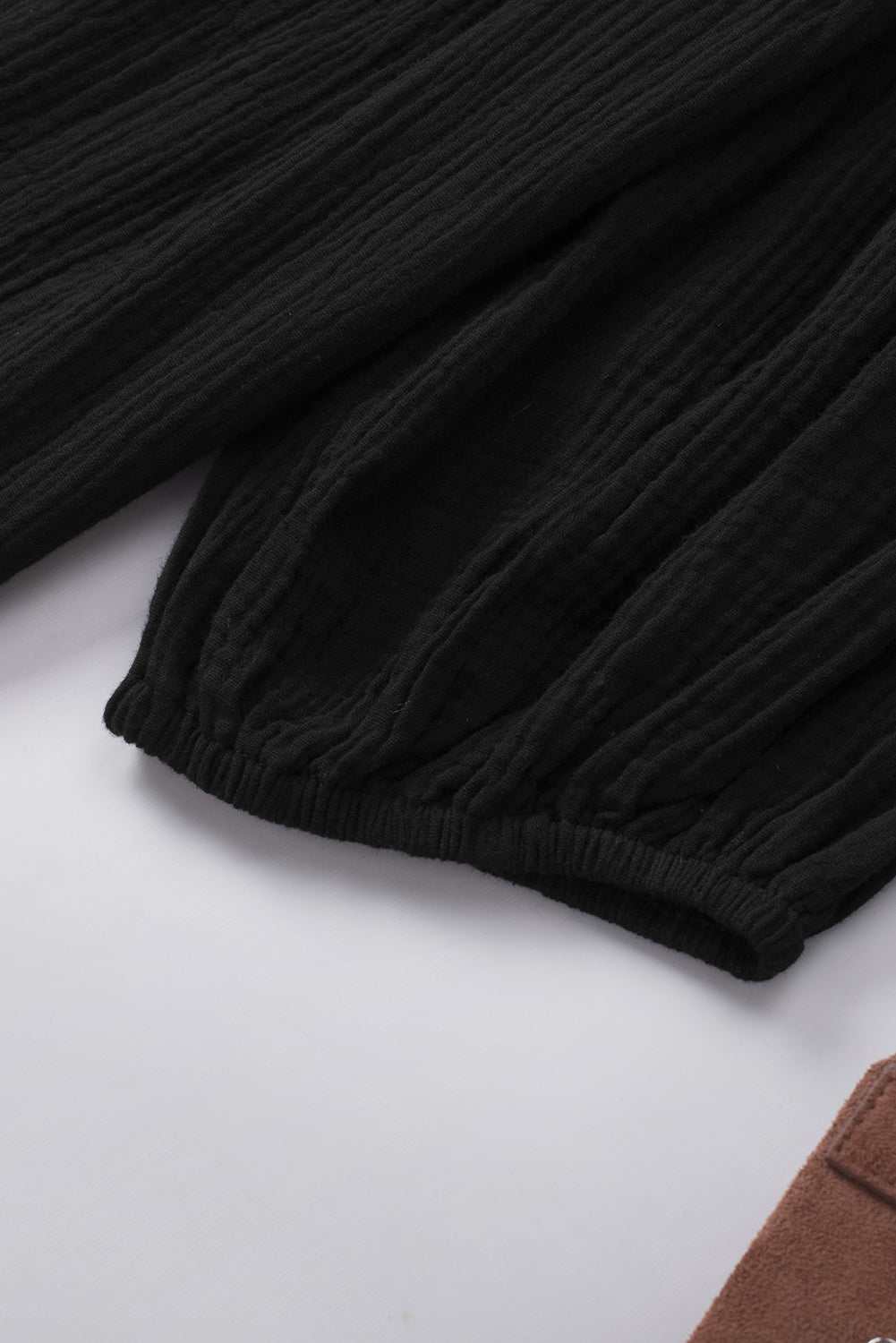 Dropped shoulder V-neck blouse in black cotton fabric.