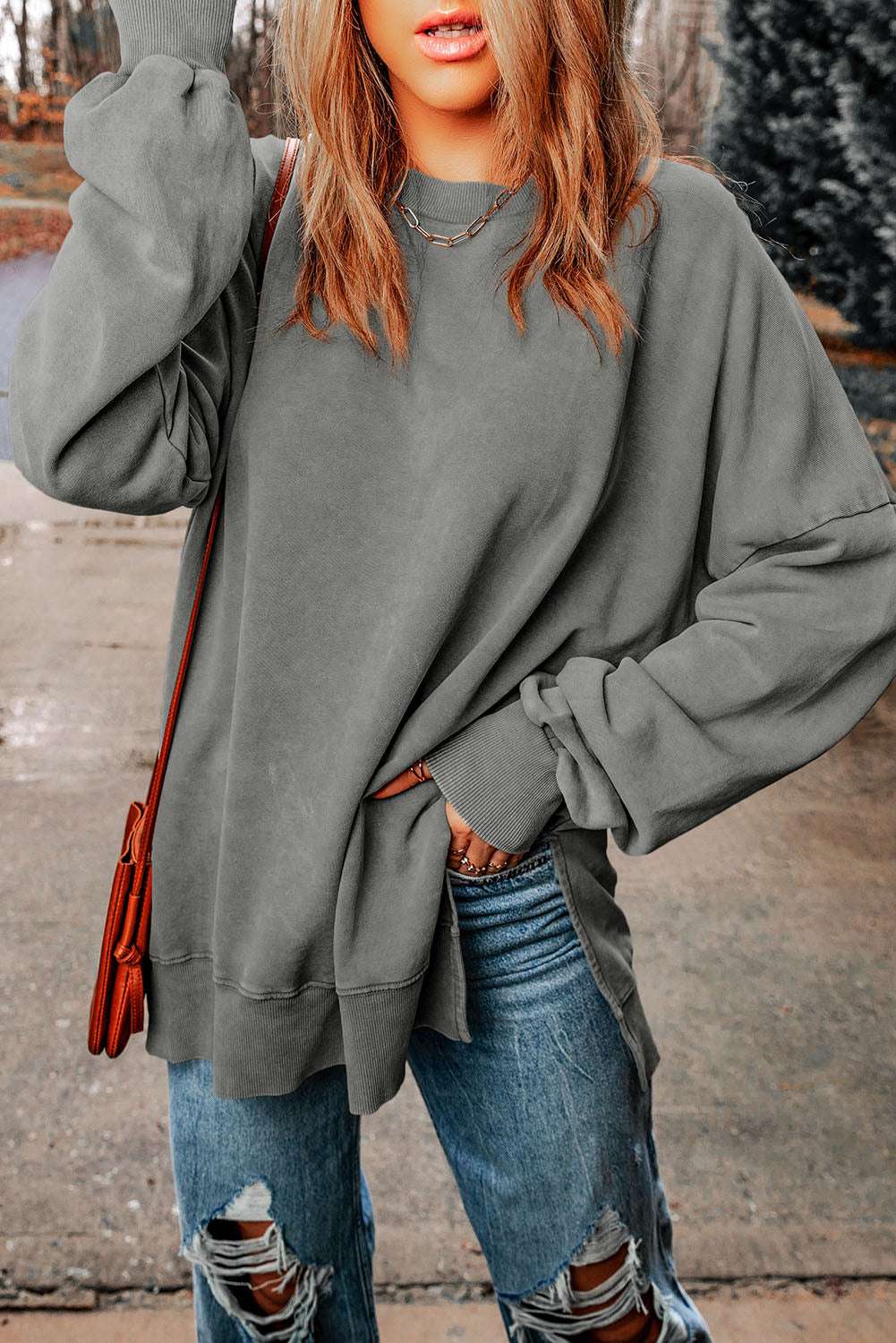 Dropped shoulder long sleeve blouse with round neck in casual solid design.