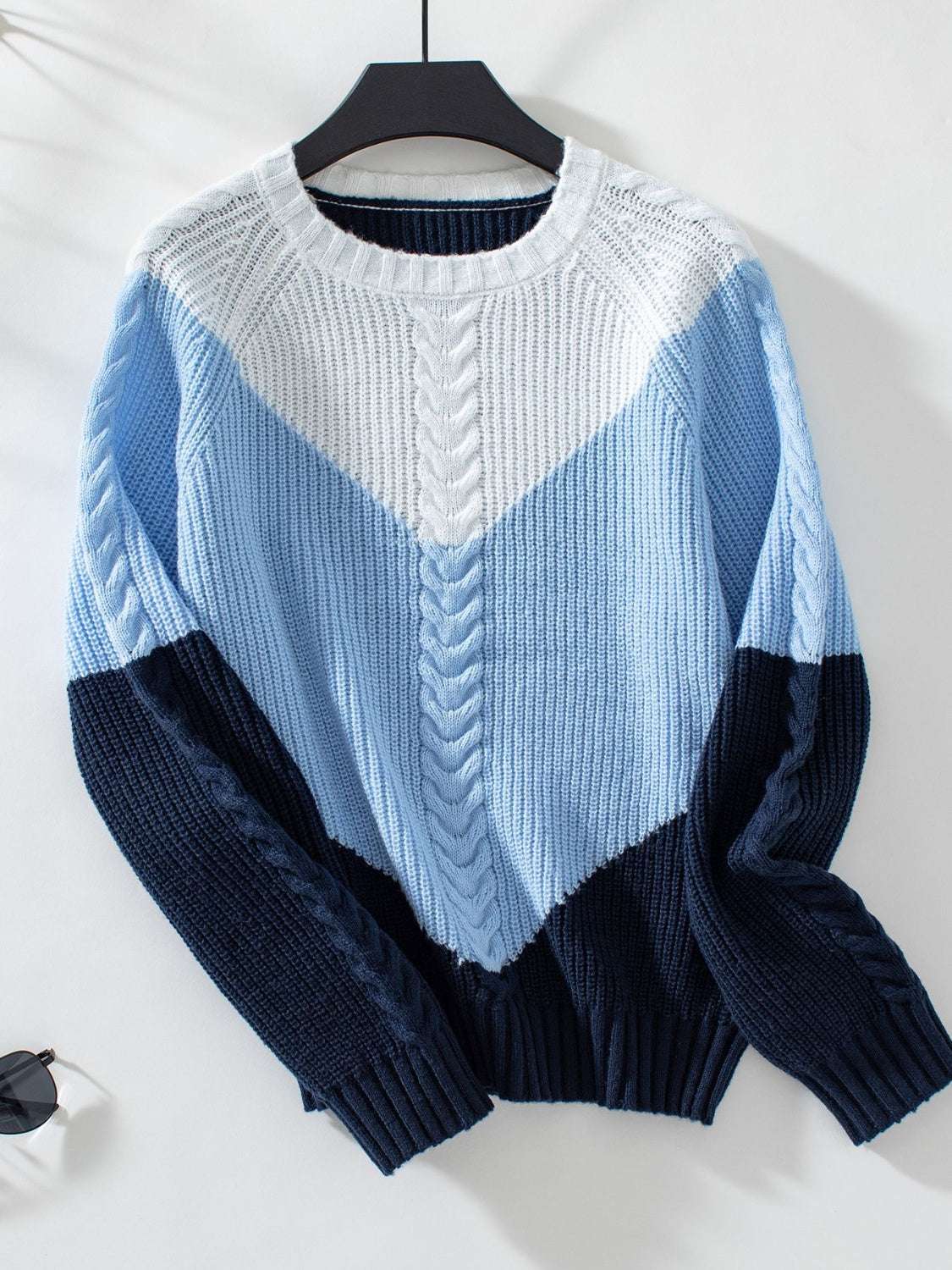 Color block round neck long sleeve sweater in shades of blue and white.