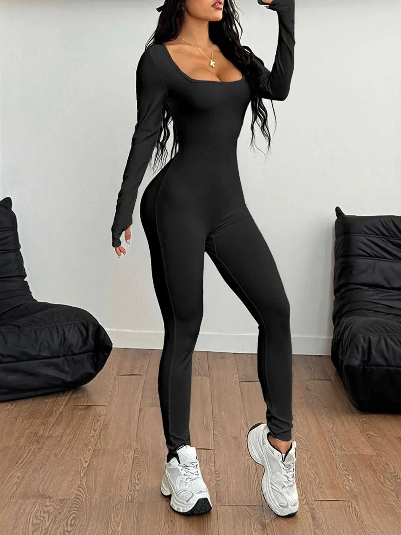 Square neck long sleeve active jumpsuit, highly stretchy nylon-elastane blend, black color.
