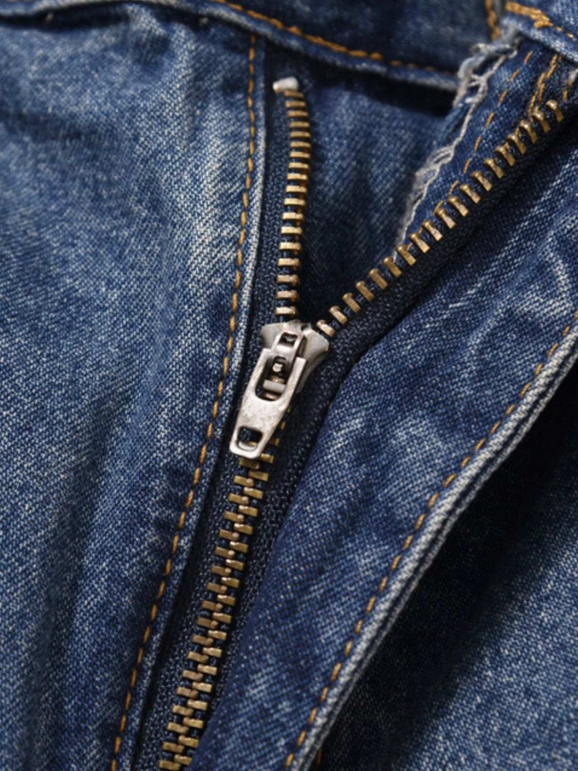 Men's washed denim Bermuda shorts with zipper detail.