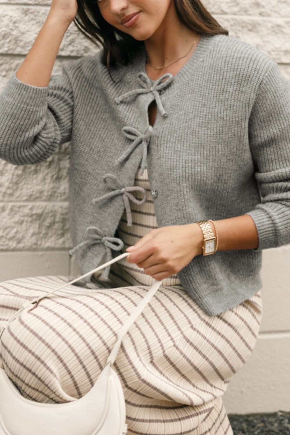 Bow round neck long sleeve cardigan made of viscose, polyester, and polyamide.