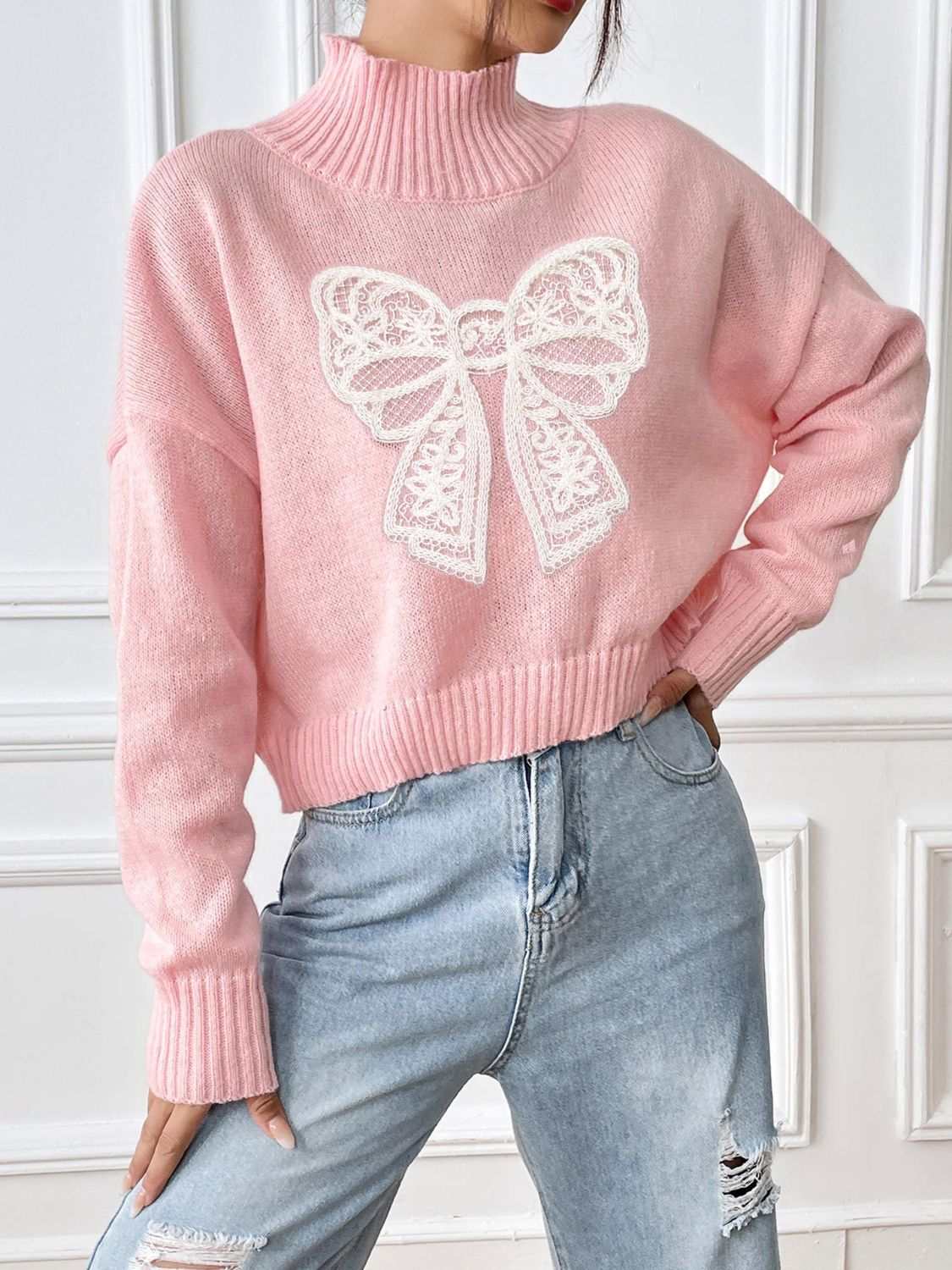 Pink bow turtleneck long sleeve sweater with ribbed cuffs and hem.
