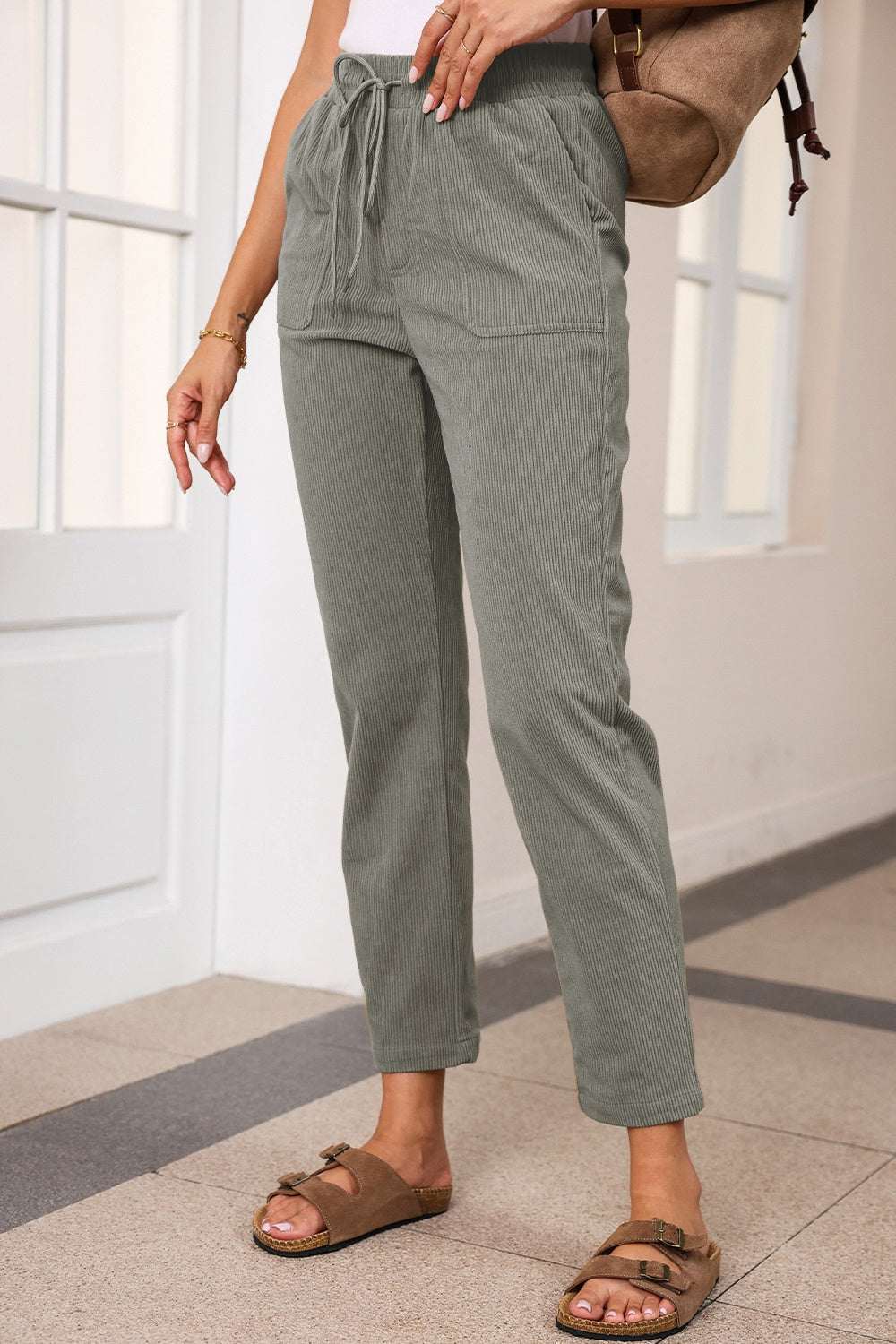 Drawstring straight pants with pockets in green, 100% polyester.