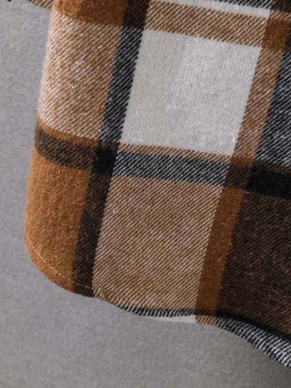 Close-up of plaid pattern on men's hooded flannel jacket.