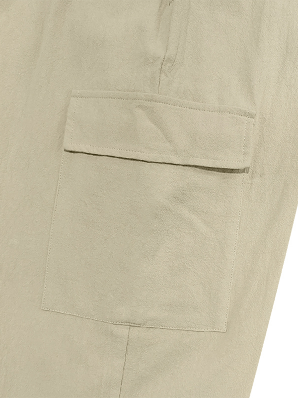 Casual cuffed multi-pocket drawstring trousers in beige cotton fabric.