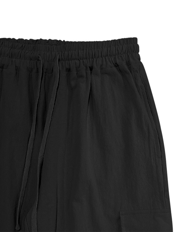 Casual cuffed multi-pocket drawstring trousers in black cotton fabric.