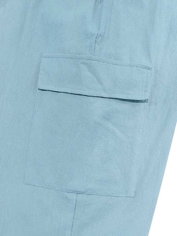 Casual cuffed multi-pocket drawstring trousers in light blue with welt pocket detail.