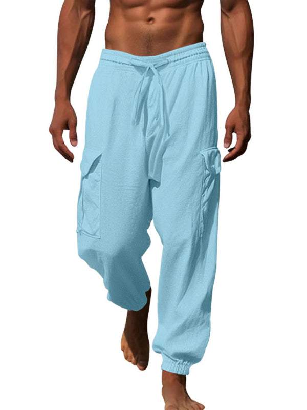 Casual cuffed multi-pocket drawstring trousers in light blue, 100% cotton, spring-summer style.