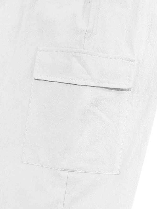 Detail of casual cuffed multi-pocket drawstring trousers in cotton fabric.