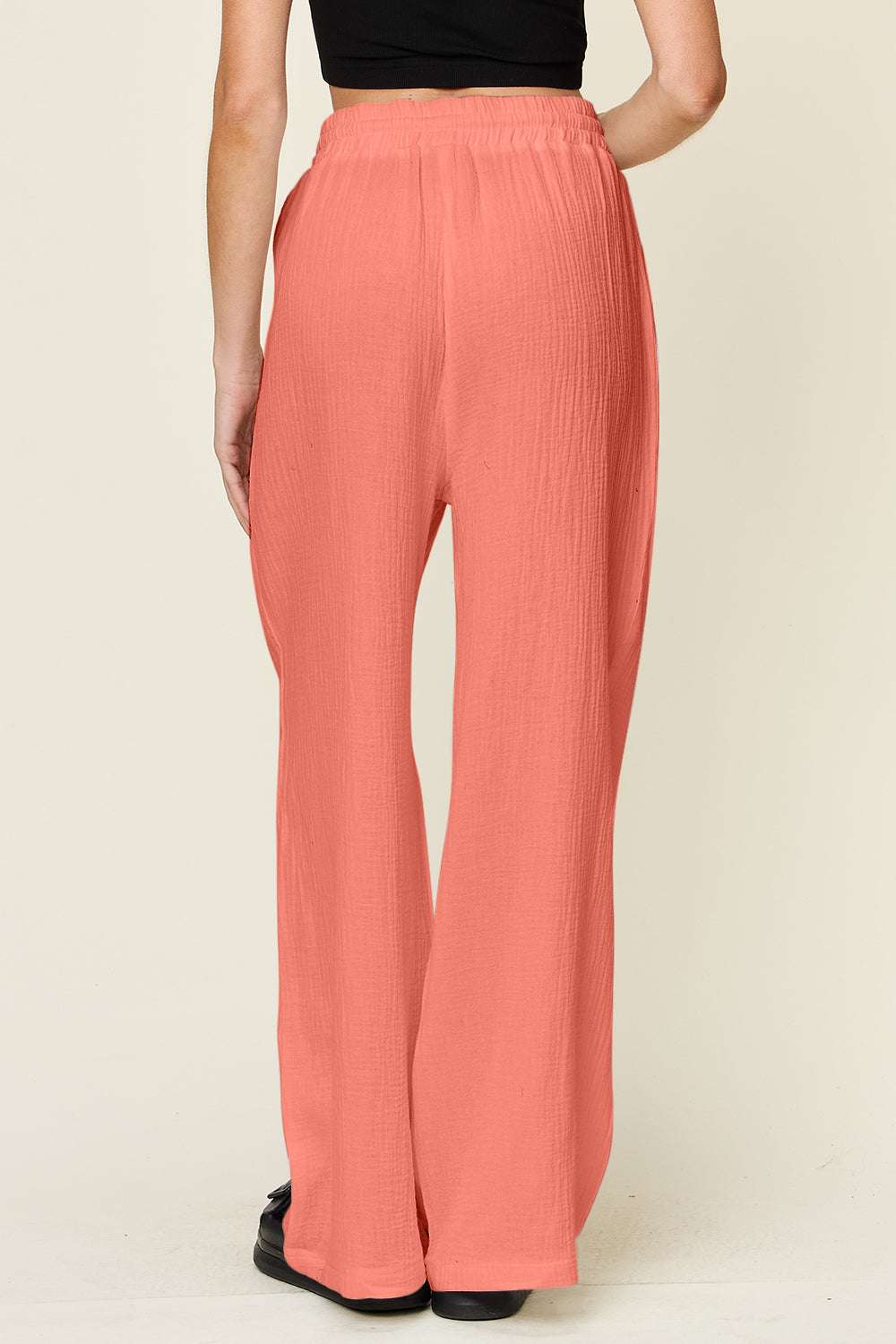 Double Take Full Size Texture Drawstring Wide Leg Pants in coral, 100% cotton with an adjustable drawstring, back view.