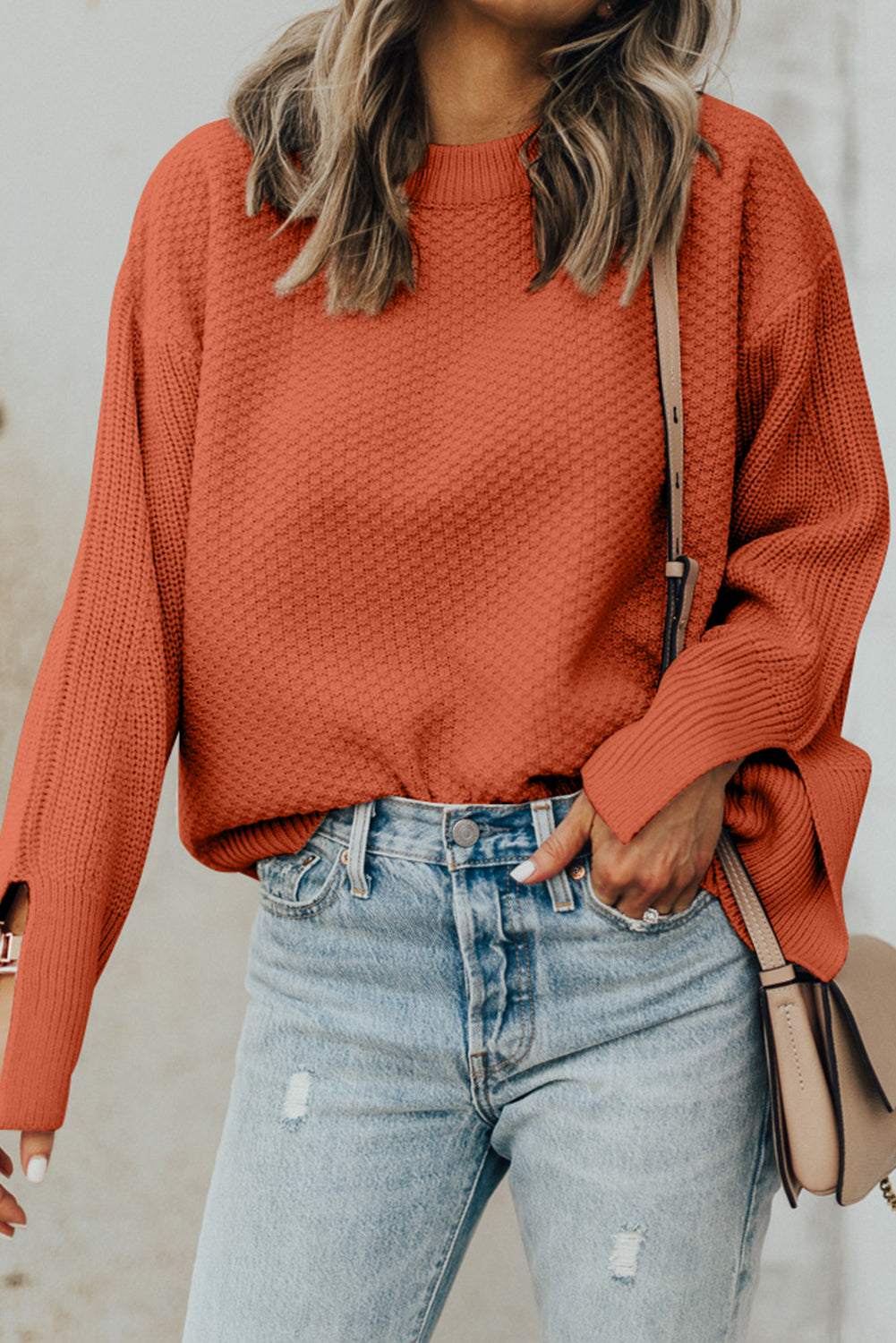 Textured round neck long sleeve sweater with slit detail, slightly stretchy material.