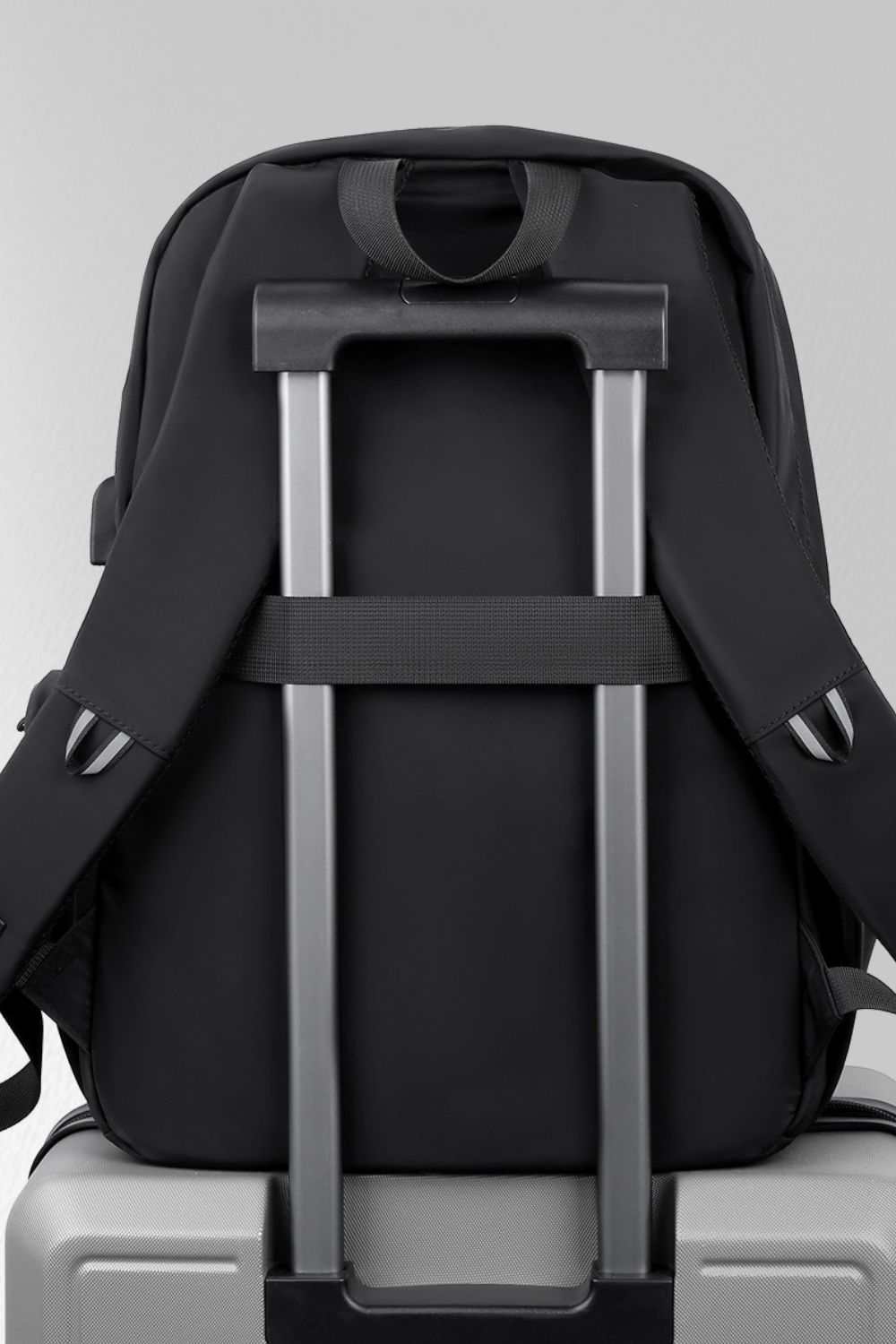 Multi-pockets solid color backpack bag with luggage strap.