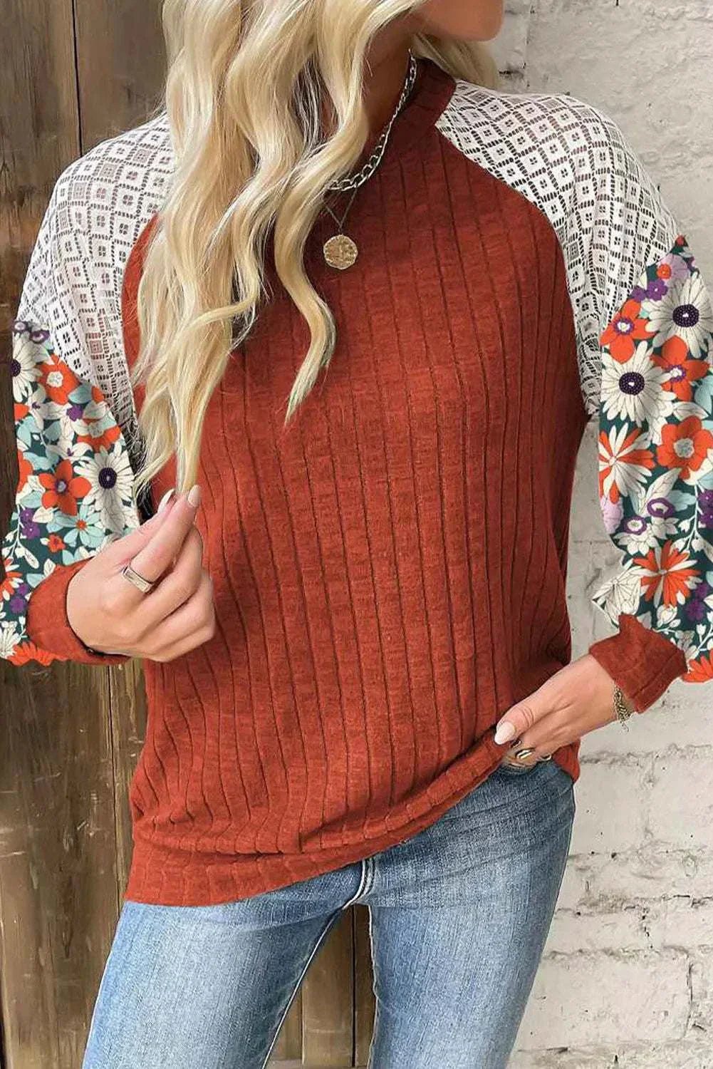 Printed Round Neck Long Sleeve Top with floral sleeves in rust color, made of polyester and elastane.