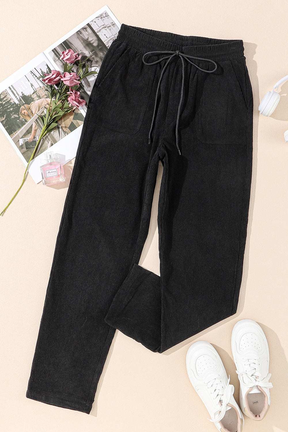 Black drawstring straight pants with pockets, 100% polyester.