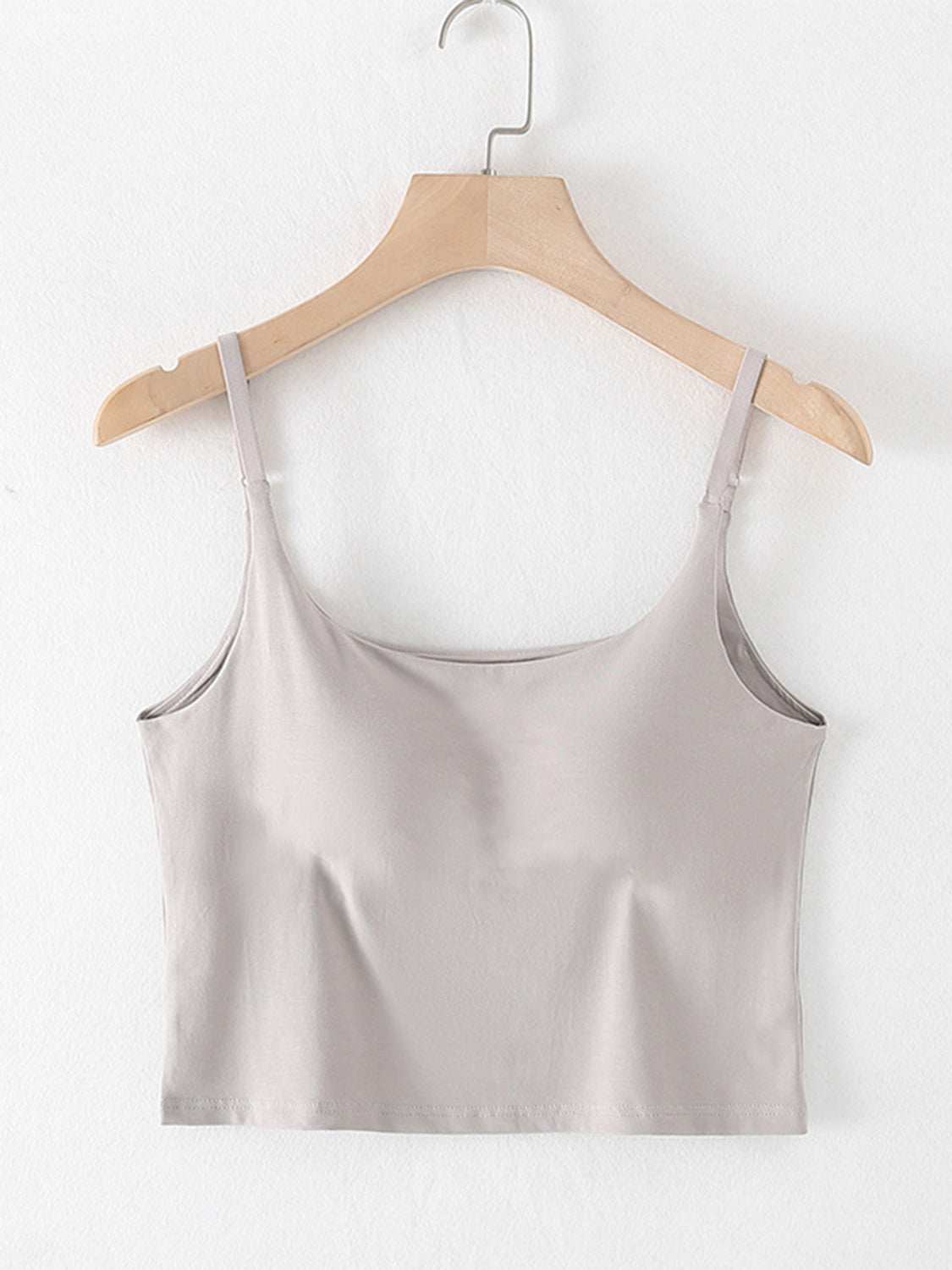 Scoop neck cropped cami with chest pads on hanger.