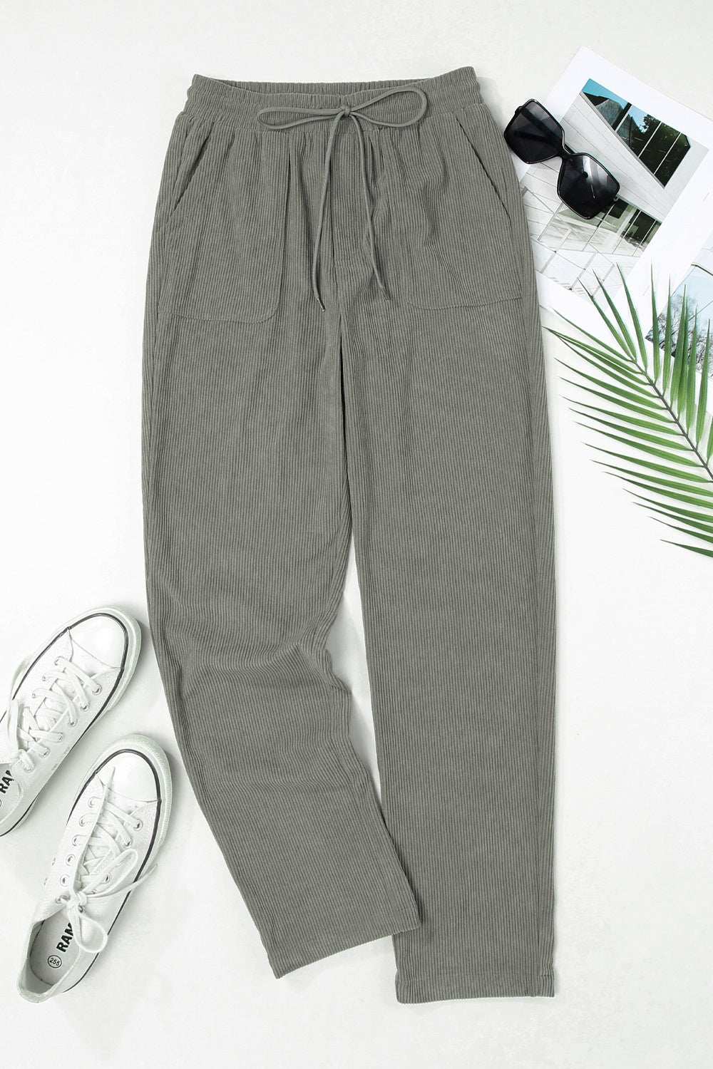 Drawstring straight pants with pockets in gray, made of 100% polyester.