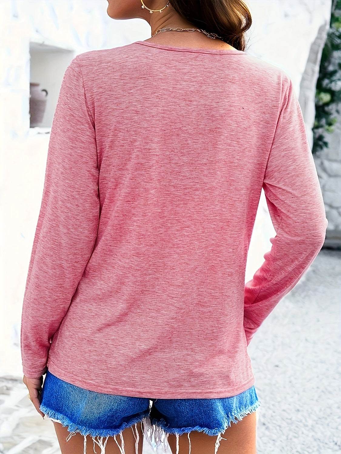 Crisscross V-neck long sleeve T-shirt in pink, slightly stretchy polyester blend.