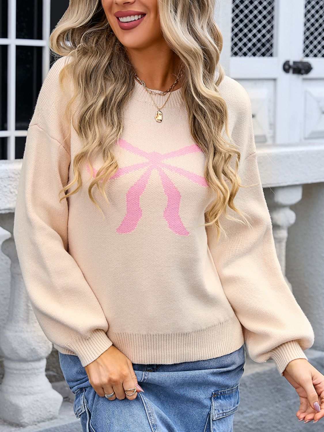 Angel Wings Bow Graphic Round Neck Long Sleeve Sweater in beige with pink design, moderate stretch, 85% acrylic, 15% polyester.