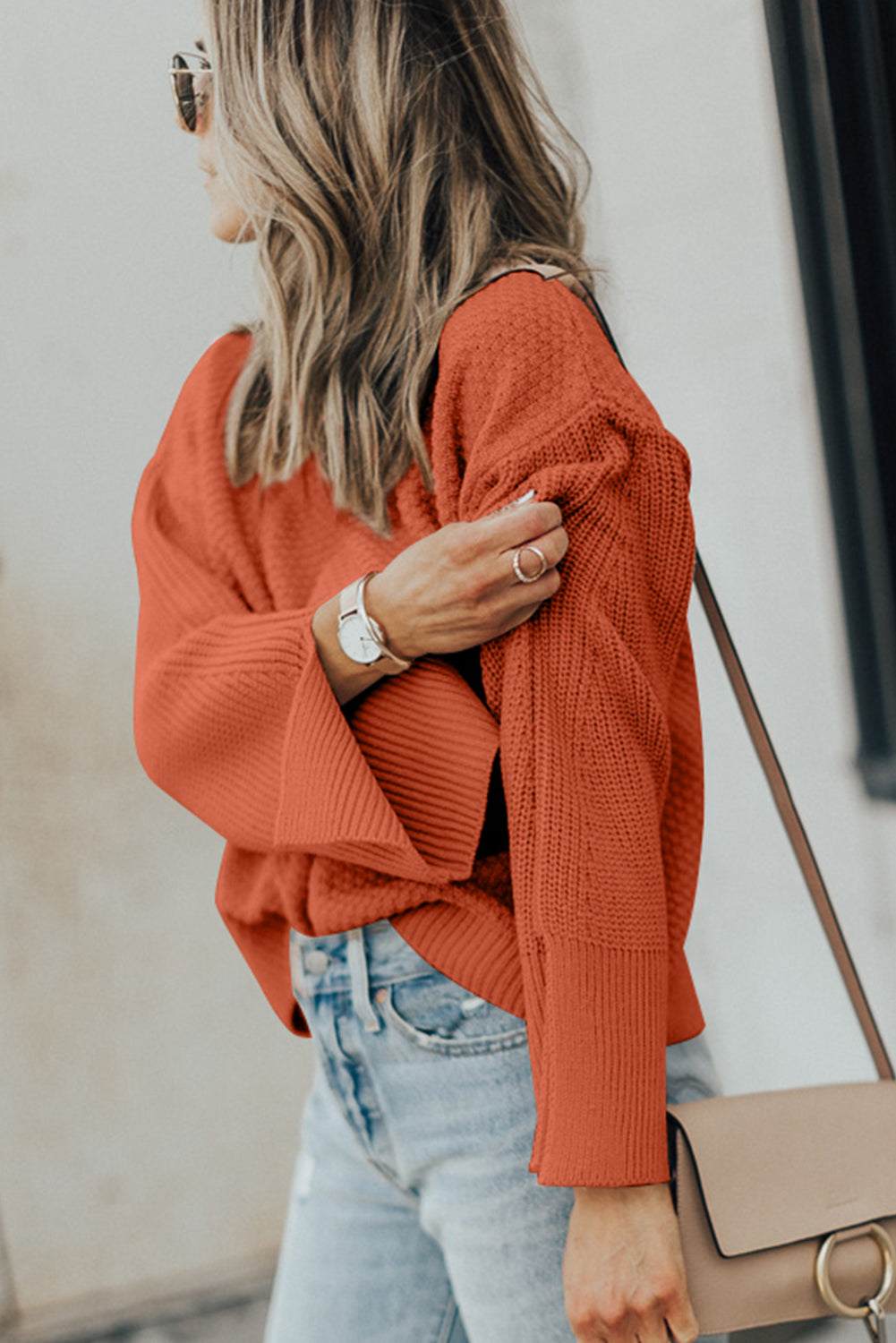 Textured round neck long sleeve sweater with slit, slightly stretchy knit.