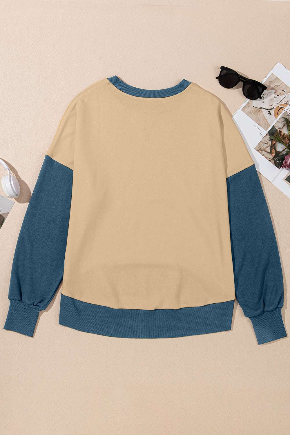 Contrast round neck long sleeve sweatshirt with blue cuffs and hem, laid flat.