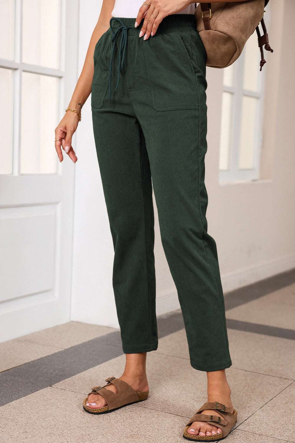 Drawstring straight pants with pockets, 100% polyester, opaque, green color.