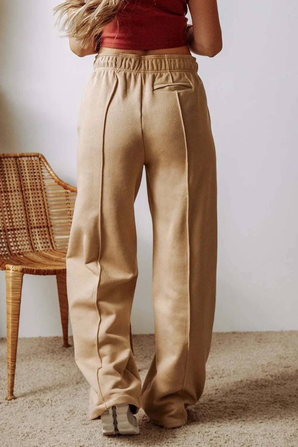 Drawstring wide leg pants with pockets in beige, featuring a comfortable fit and stylish design.