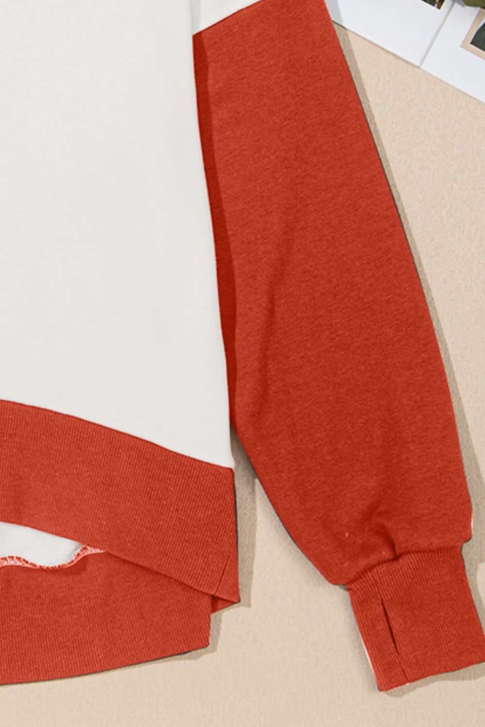 Contrast round neck long sleeve sweatshirt with red sleeves and white body.
