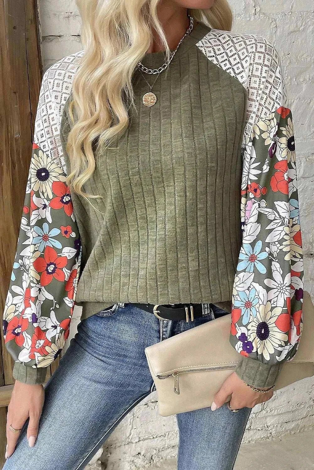 Printed round neck long sleeve top with floral pattern and ribbed texture.