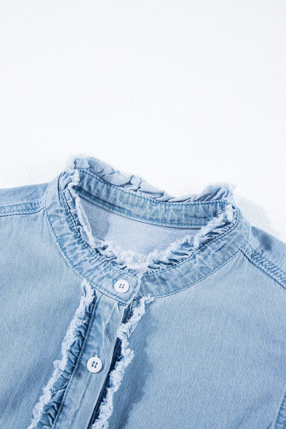 Button down raw hem ruffled denim shirt made of 100% cotton.