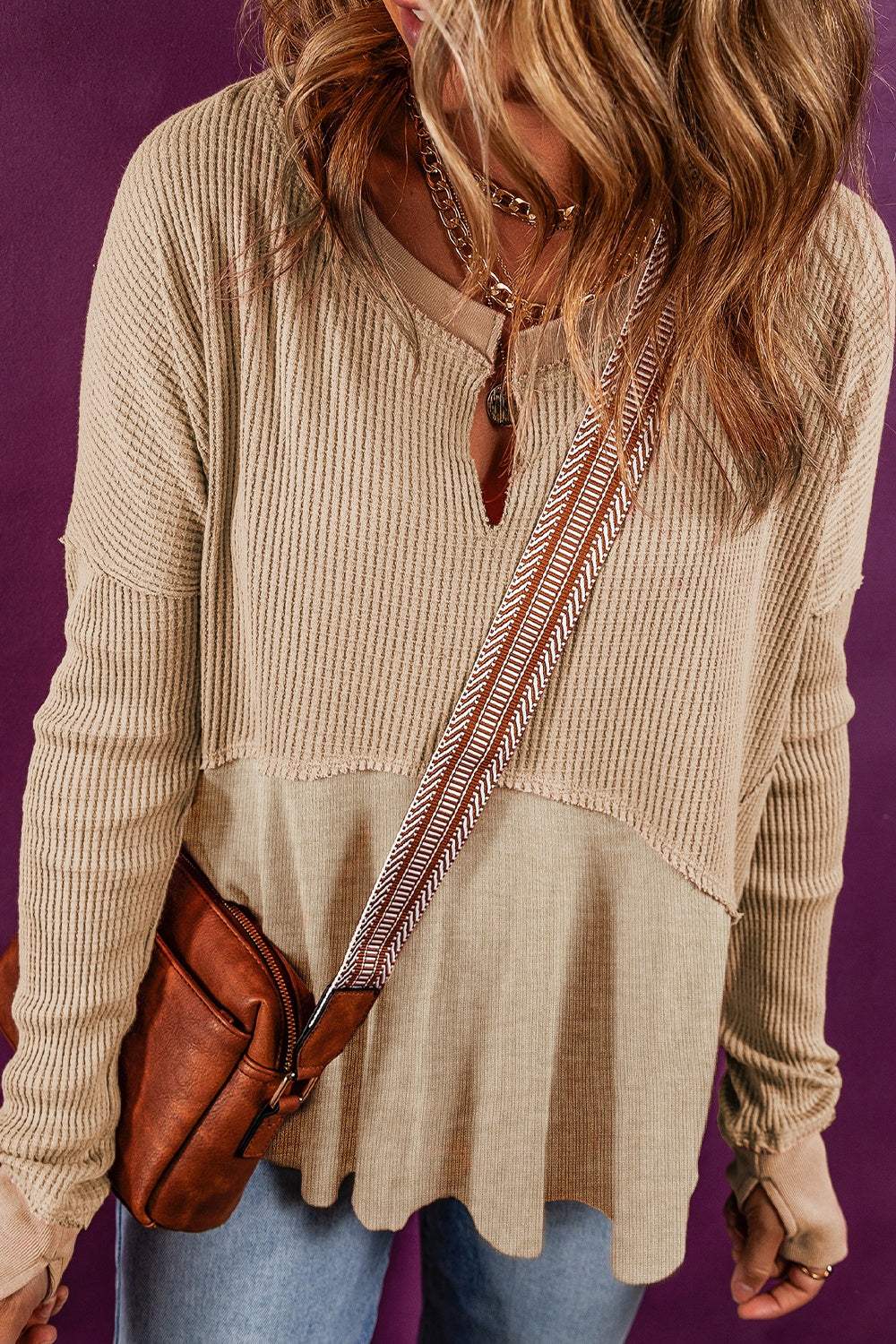 Notched neck long sleeve slit blouse, basic style, slightly stretchy, beige color, worn with jeans and crossbody bag.