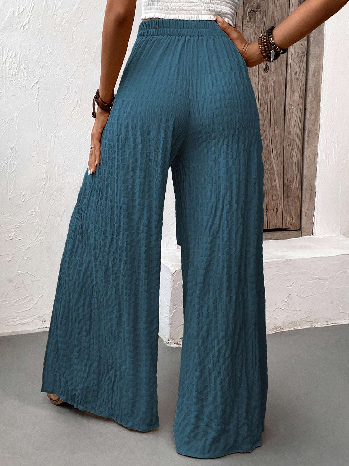 Wide leg pants with slits, honey tie, and opaque texture.