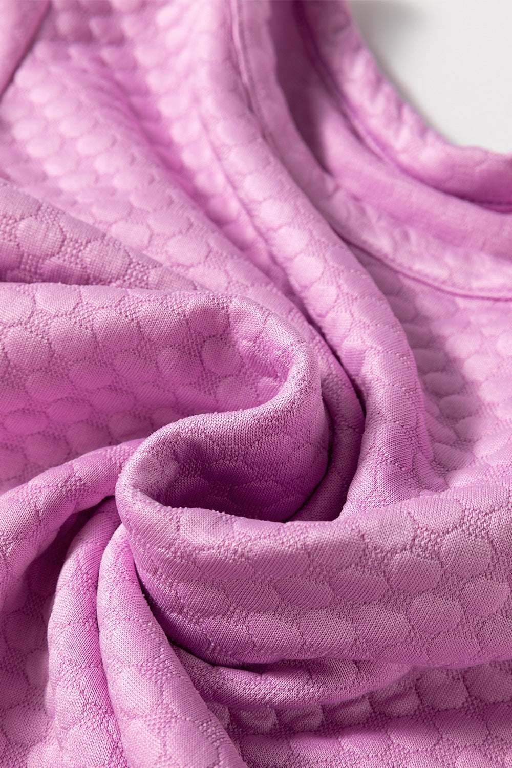 Textured round neck blouse fabric in purple.