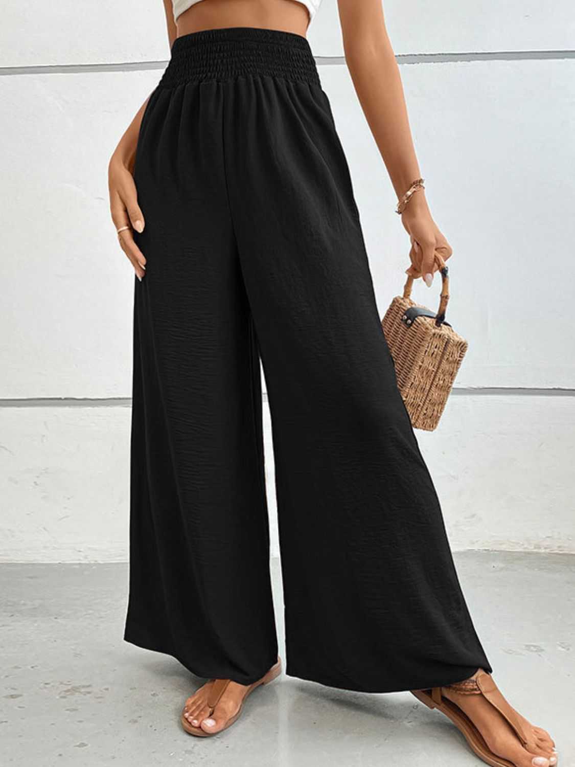 Casual black long pants with wide waistband, relaxed fit, solid pattern.