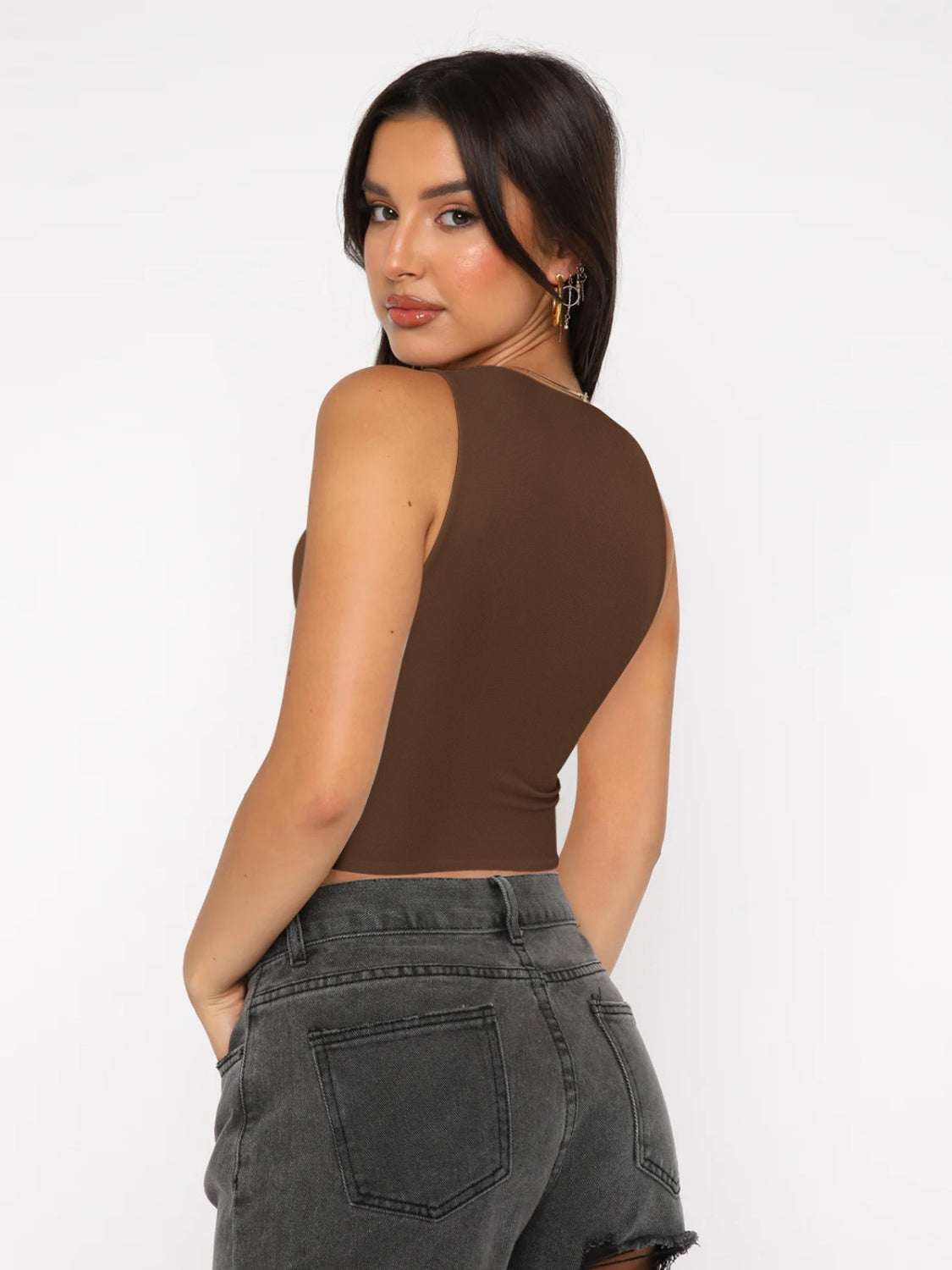 Round neck cropped tank in brown, slightly stretchy fabric, paired with gray jeans.