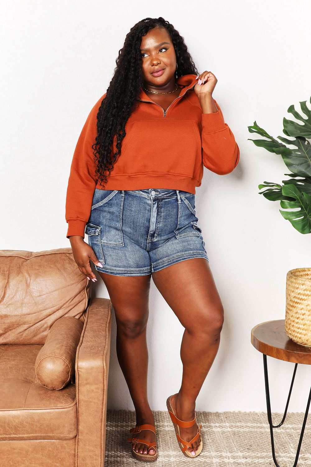 Double Take Half-Zip Long Sleeve Hoodie in solid color with a collared neck and ribbed features, paired with denim shorts.