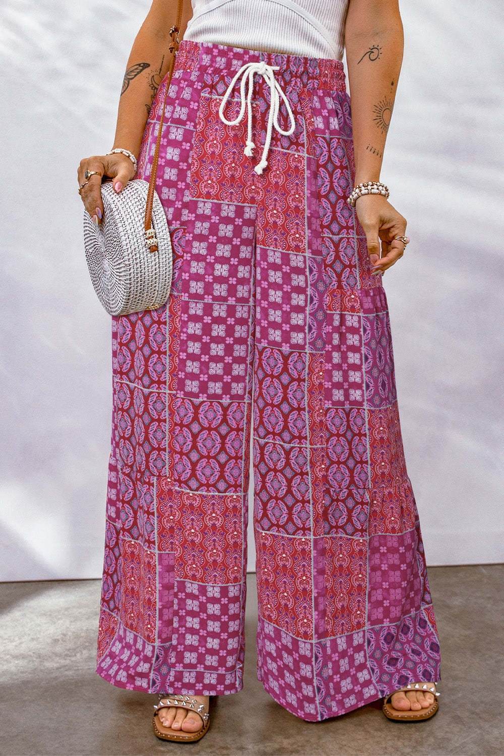 Full Size Drawstring Printed Wide Leg Pants in pink with white drawstring detail.