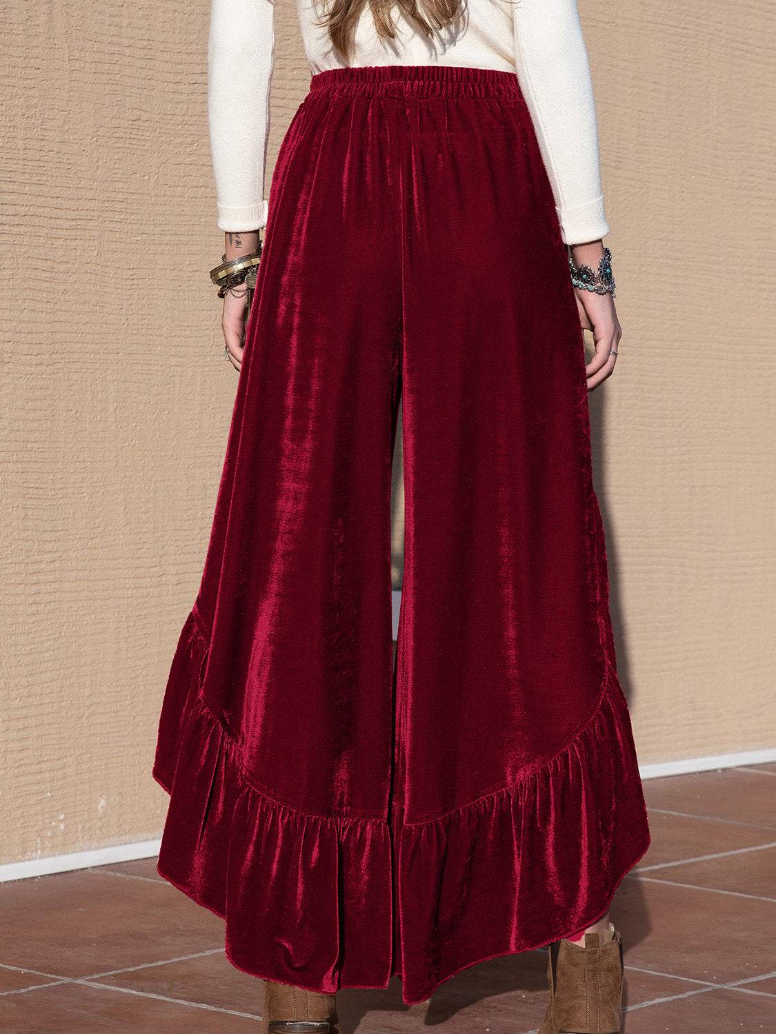 Red slit ruffled wide leg pants made of polyester and elastane.
