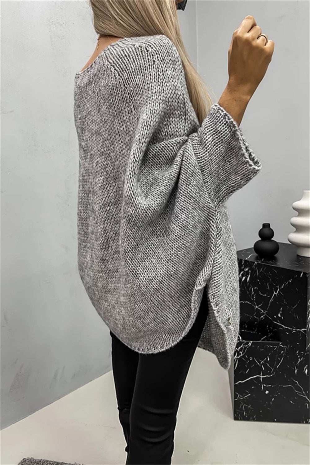 Gray round neck batwing sleeve sweater with a loose fit, made from 100% polyester.