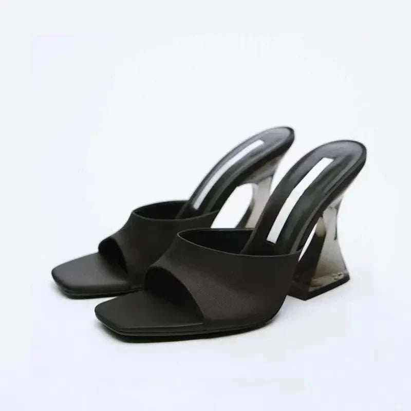 Black open toe high heel sandals with suede straps and sleek design.