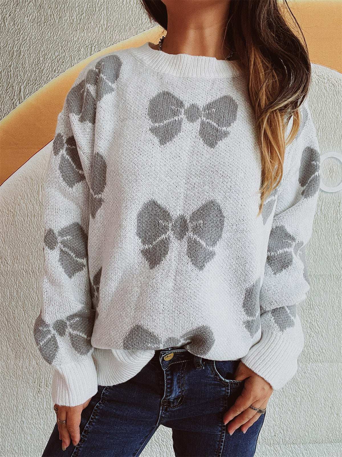 Bow Round Neck Dropped Shoulder Sweater with bow pattern, moderate stretch, polyester-acrylic blend.