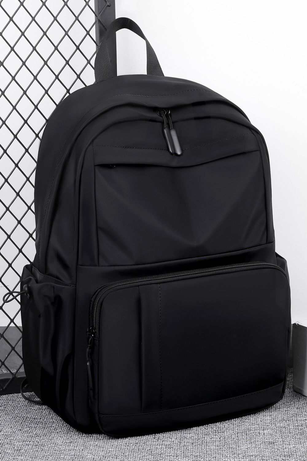 Large black polyester multi-pockets backpack with ample storage space.