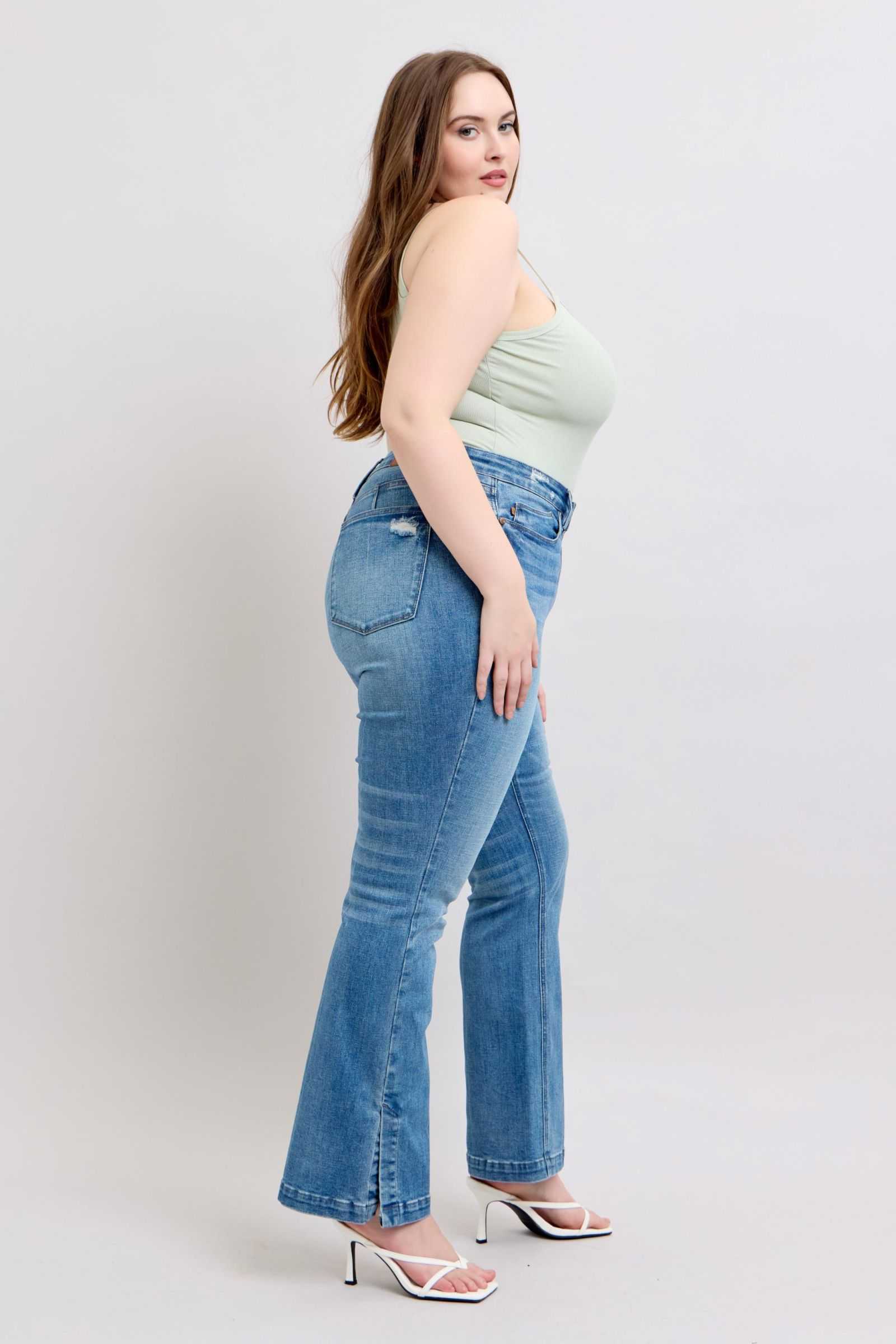 Judy Blue HW tummy control vintage wash side slit slim bootcut jeans on model.