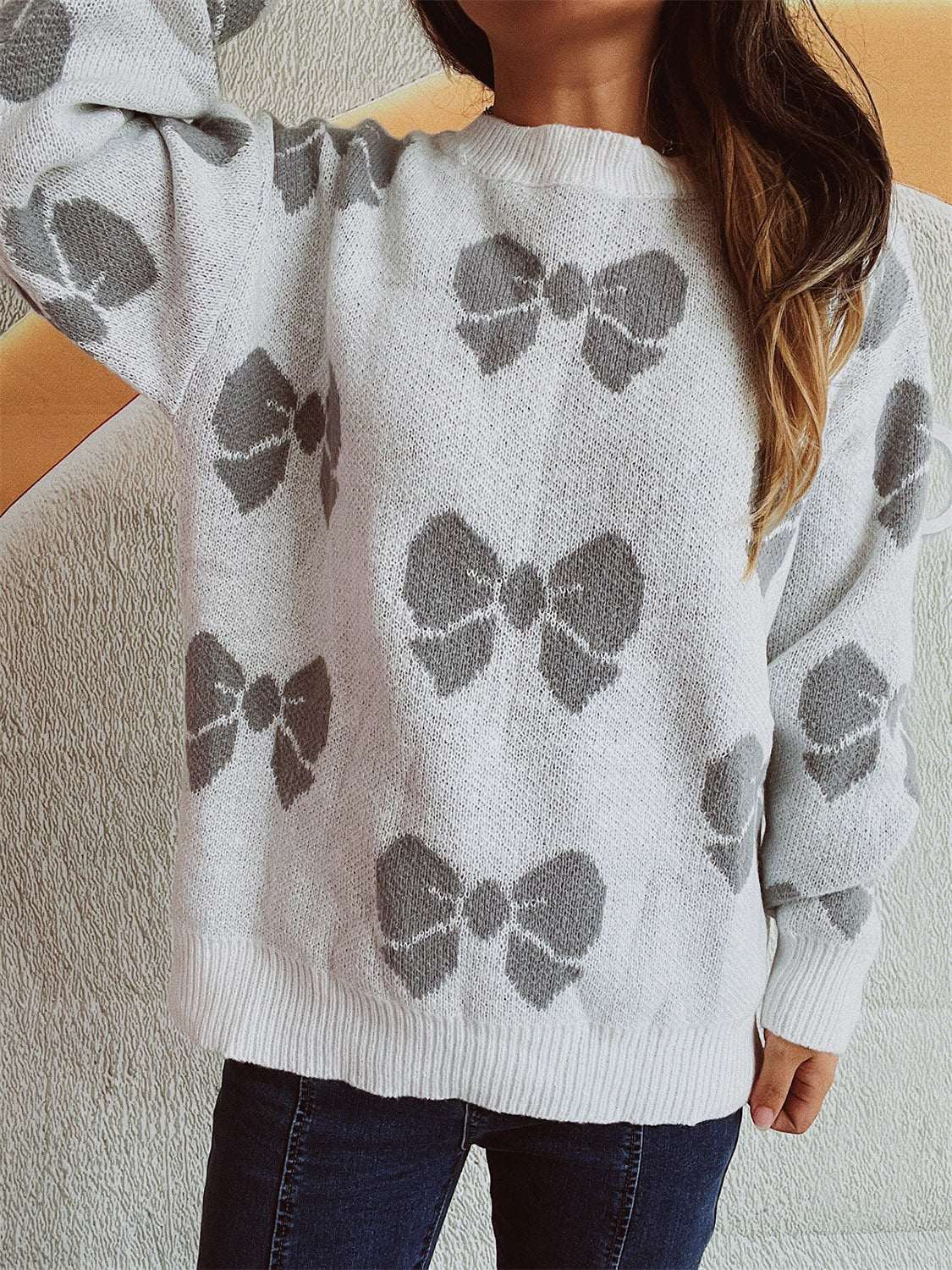 Bow Round Neck Dropped Shoulder Sweater with grey bow pattern, moderate stretch, polyester acrylic blend.