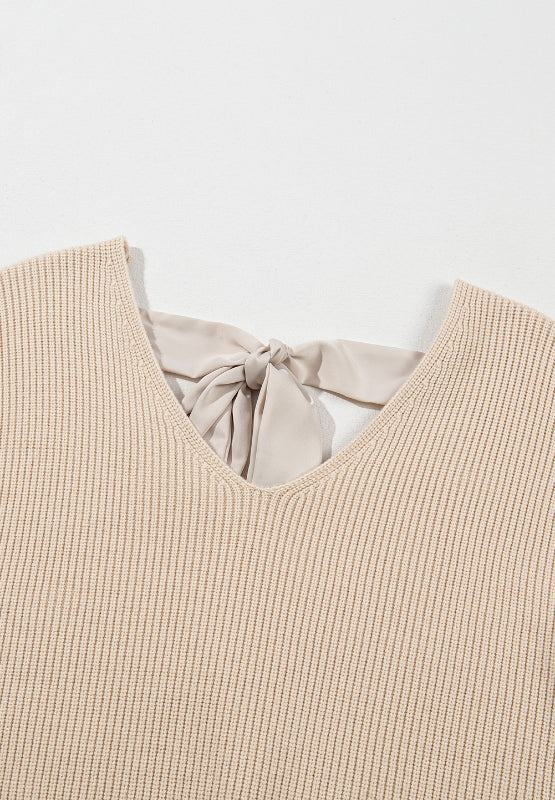 Tied back V-neck long sleeve sweater with bow detail in beige.